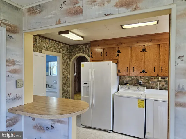 a kitchen with a refrigerator and countertop