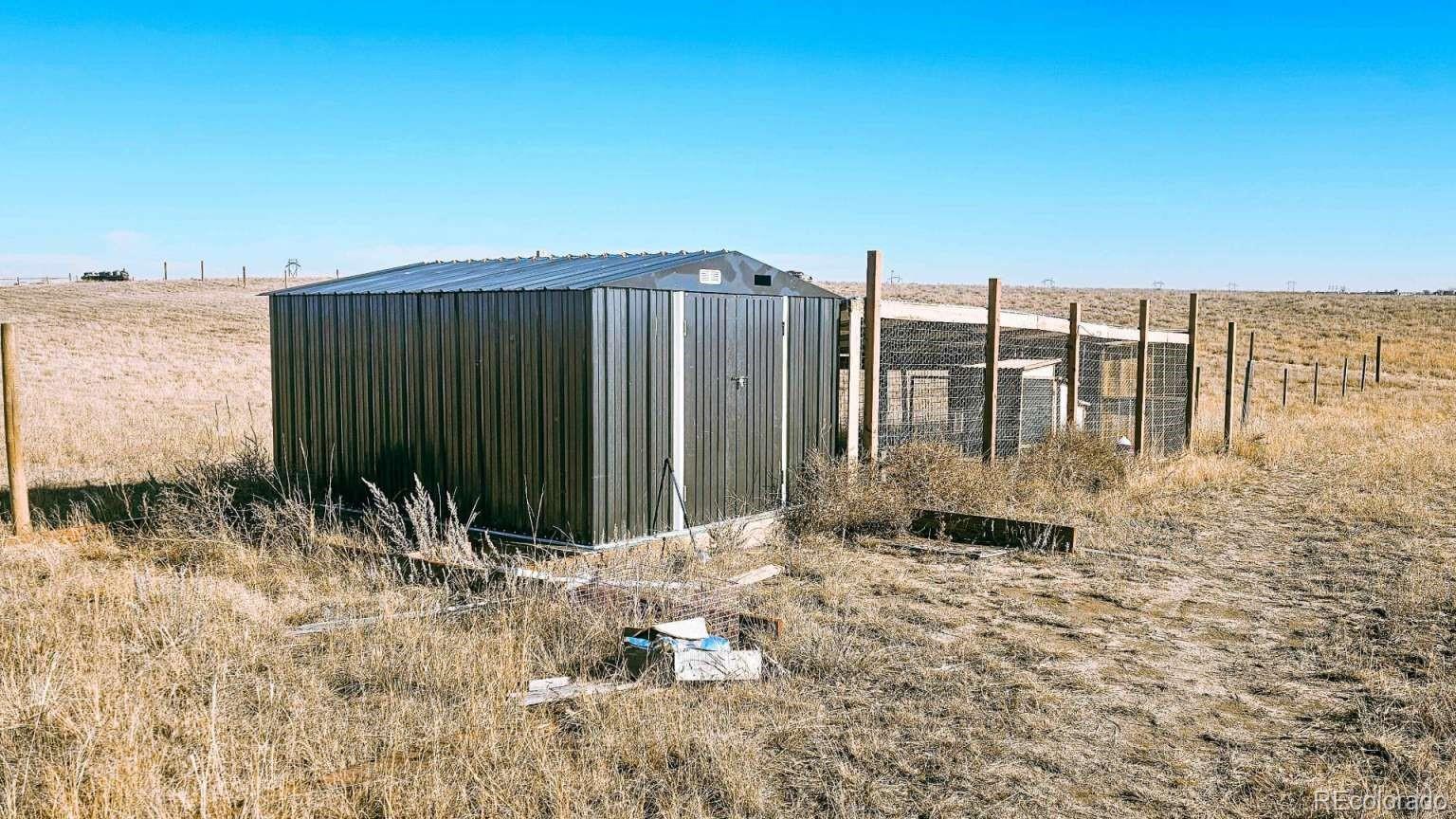 3900 County Road L Wiggins, CO 80654 - Photo 16 of 35 a backyard of a house with large trees