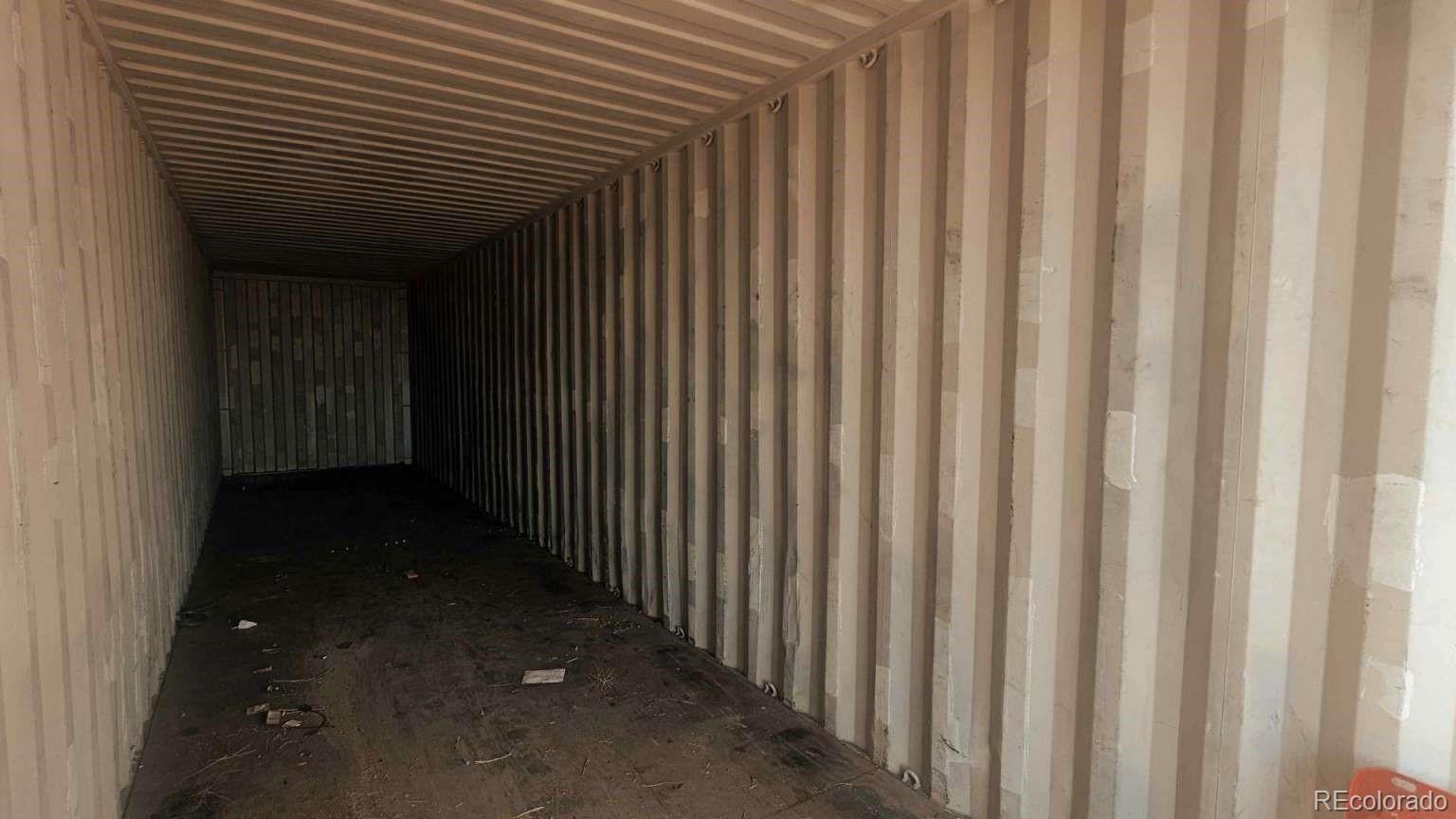 3900 County Road L Wiggins, CO 80654 - Photo 22 of 35 a view of a porch with a wooden door