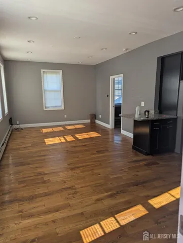 a view of a livingroom with wooden floor