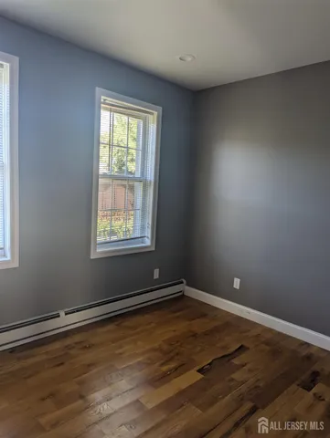 a view of wooden floor and windows in a room