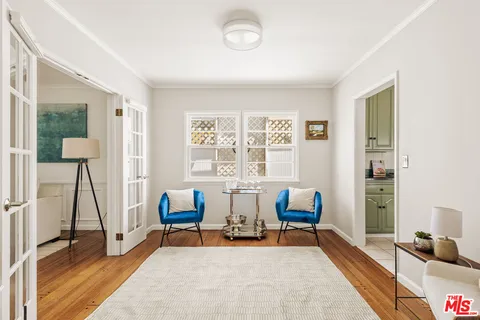 a bedroom with furniture and a window
