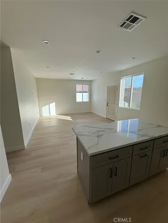 a view of kitchen and hallway with granite countertop