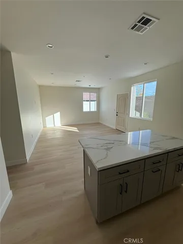 a view of kitchen and hallway with granite countertop