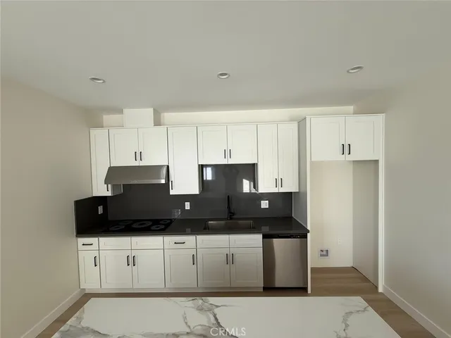 a white toilet sitting next to a shower