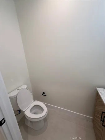 a view of a hallway with wooden floor and closet