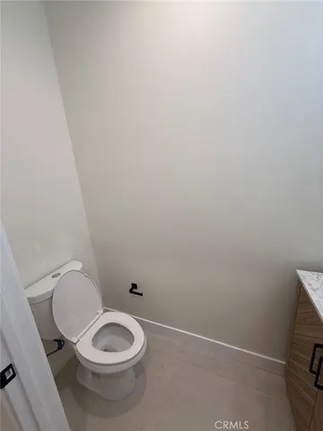 a view of a hallway with wooden floor and closet