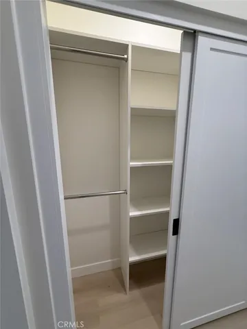 a view of a kitchen with a sink a microwave and cabinets