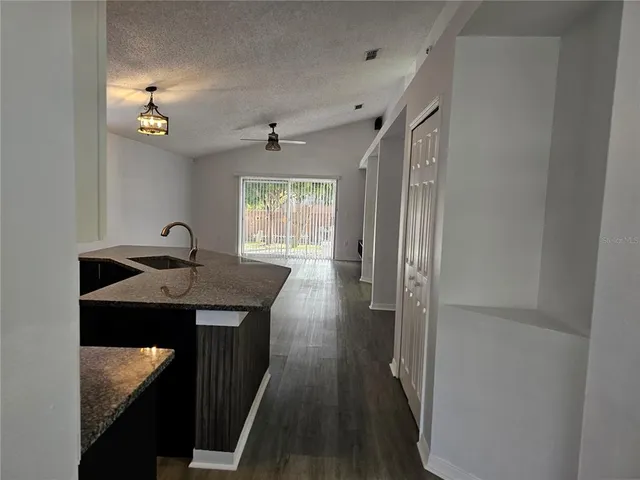 a hallway with a sink a mirror and a window