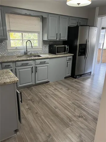 a kitchen with a sink appliances and cabinets