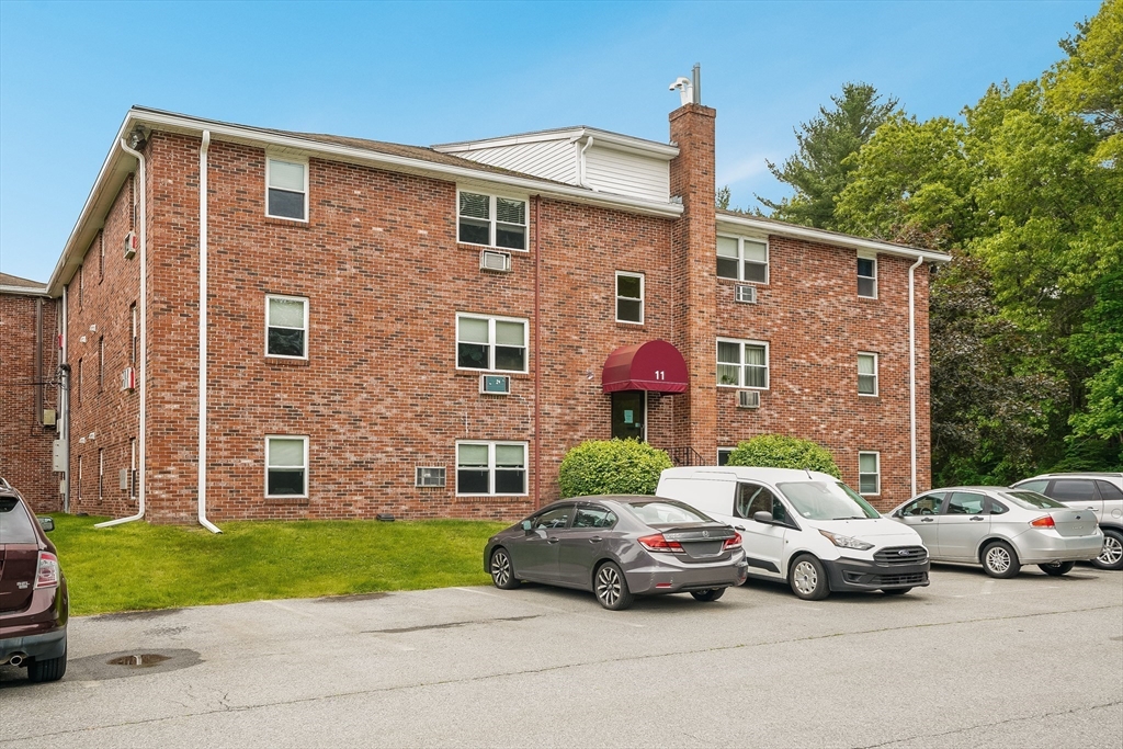 11 Cross Street, Unit 3 Chelmsford, MA 01863 - Photo 2 of 13 a couple of cars parked in front of a brick house