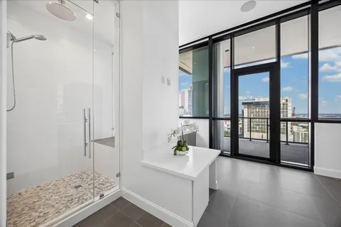 a bathroom with a tub sink and mirror