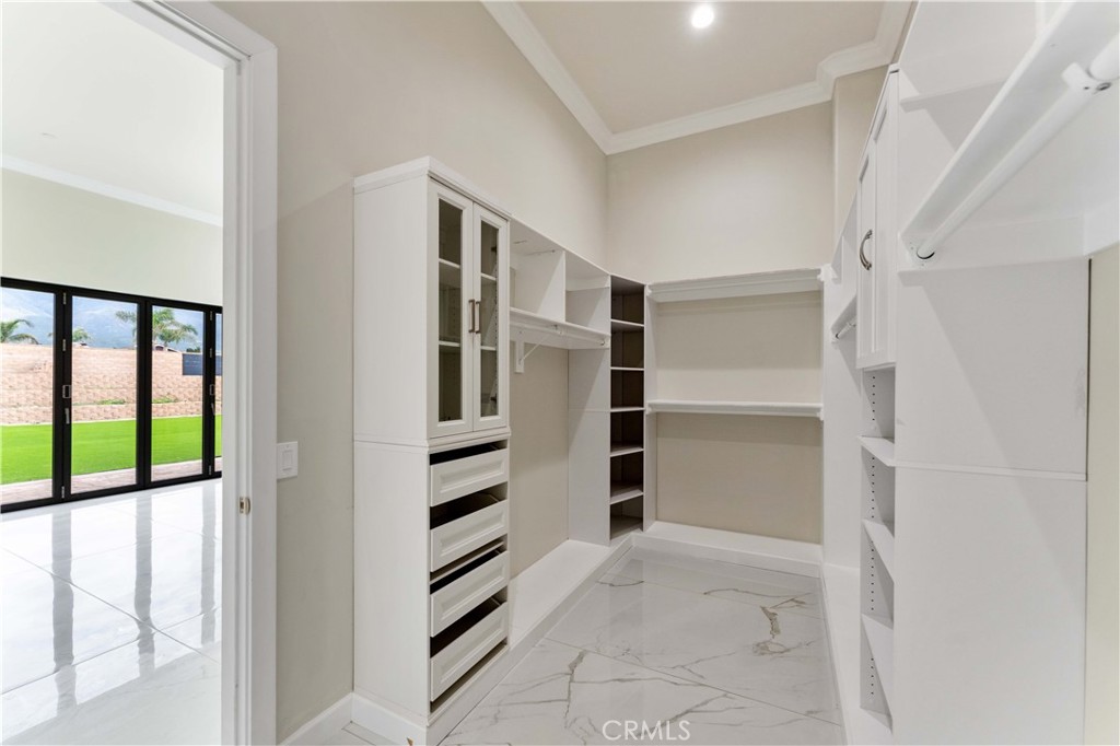 6338 Echo Mountain Rancho Cucamonga, CA 91739 - Photo 14 of 23 a view of walk in closet with empty racks
