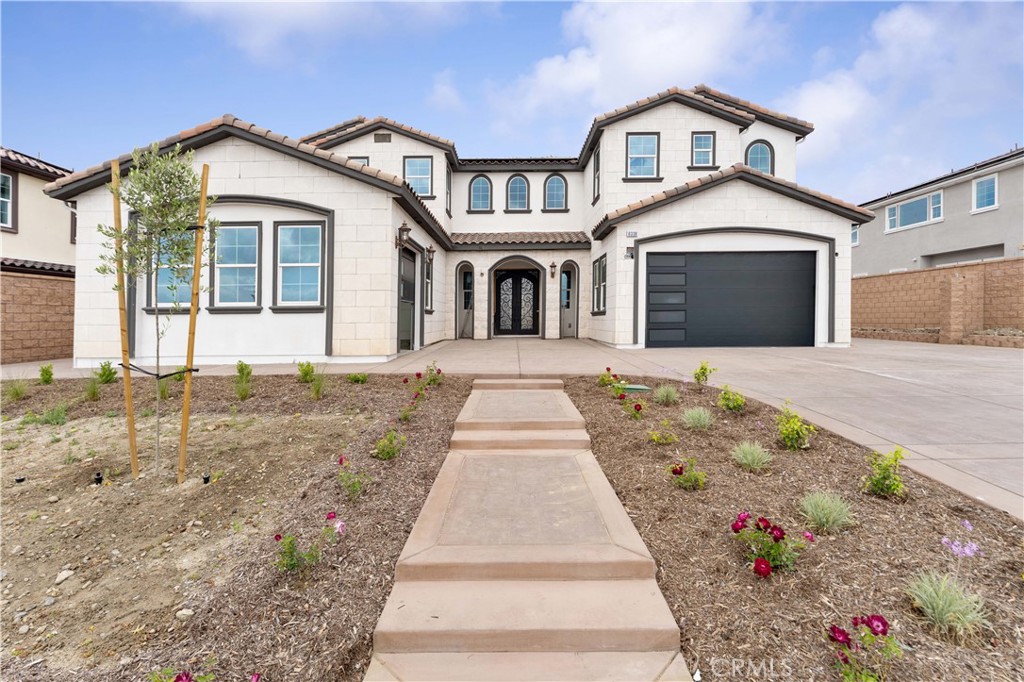6338 Echo Mountain Rancho Cucamonga, CA 91739 - Photo 2 of 23 a front view of a house with a yard