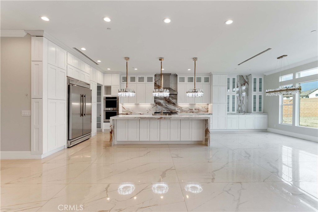 6338 Echo Mountain Rancho Cucamonga, CA 91739 - Photo 3 of 23 a large kitchen with stainless steel appliances kitchen island granite countertop a large counter top stainless steel appliances and cabinets