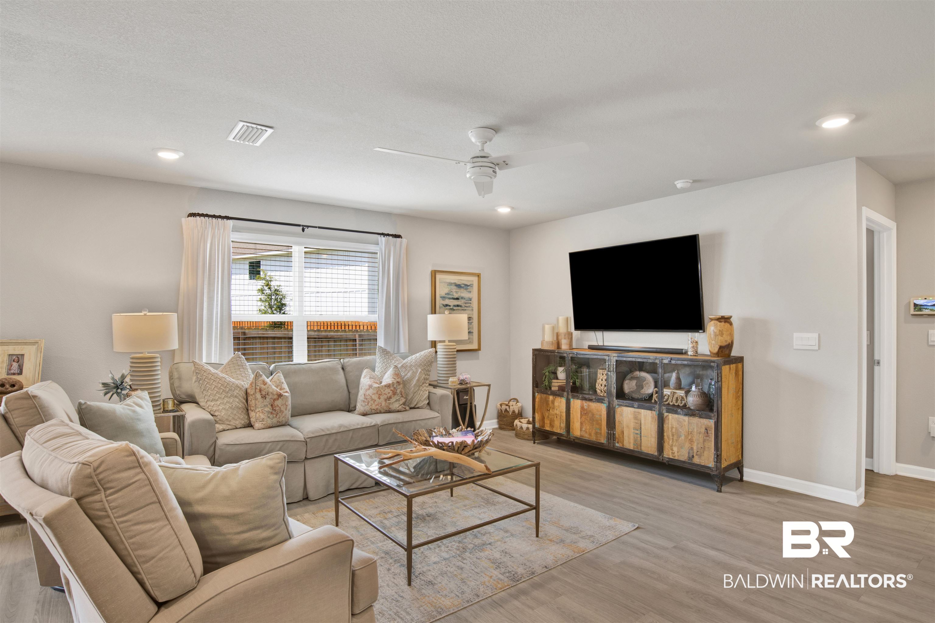 24532 Broken Sound Loop Orange Beach, AL 36561 - Photo 9 of 29 Living room featuring ceiling fan and light wood-type flooring