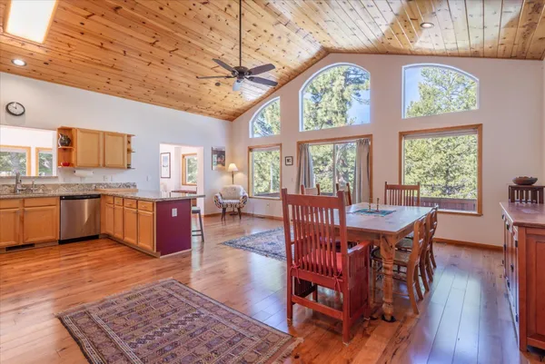 a view of a dining room with furniture a chandelier and wooden floor