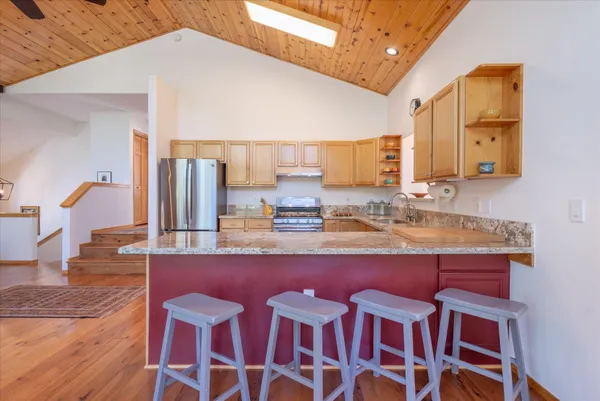 a kitchen with stainless steel appliances granite countertop a sink and cabinets