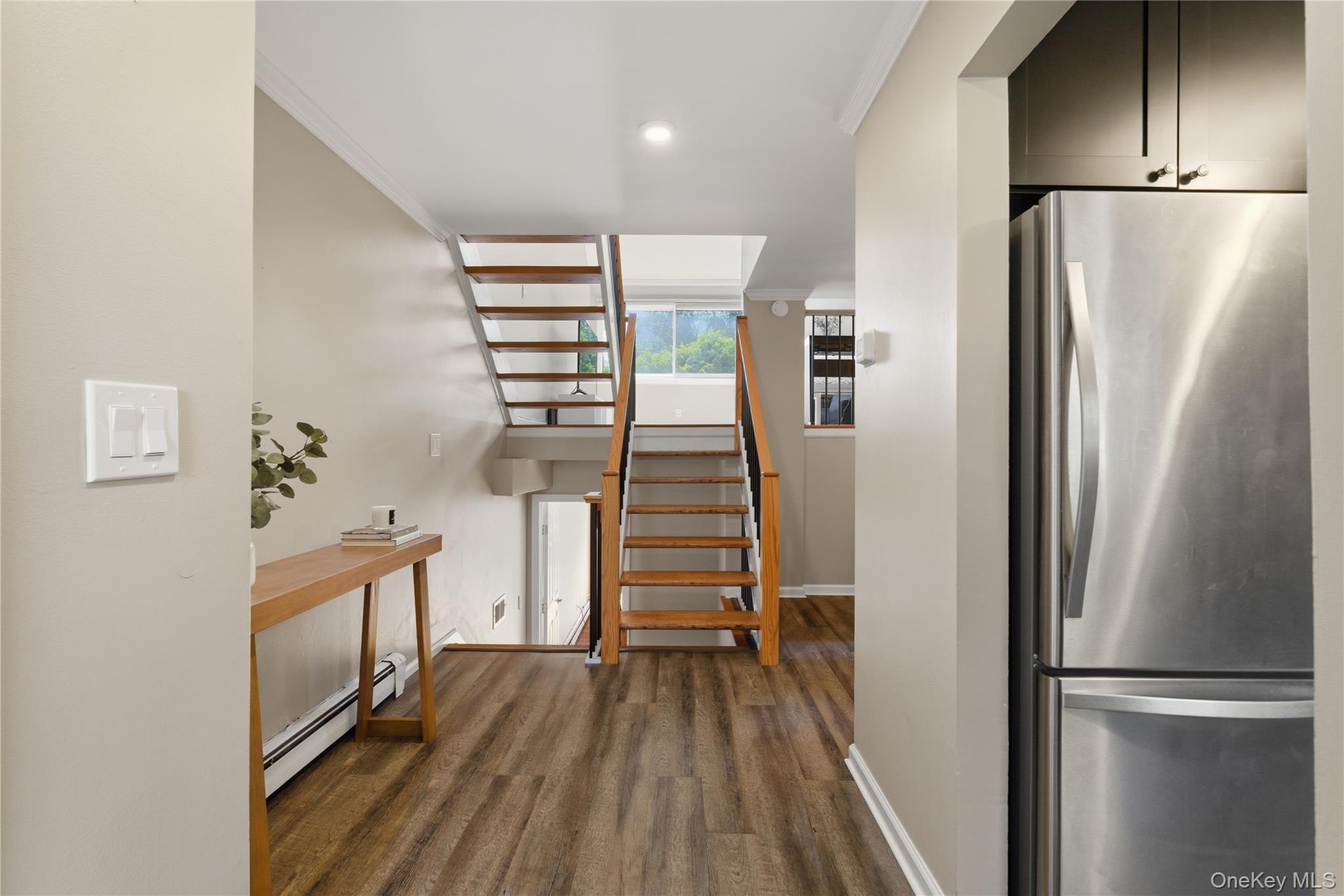245 Tree Top Crescent Rye Brook, NY 10573 - Photo 3 of 24 a view of a kitchen with wooden floor and staircase