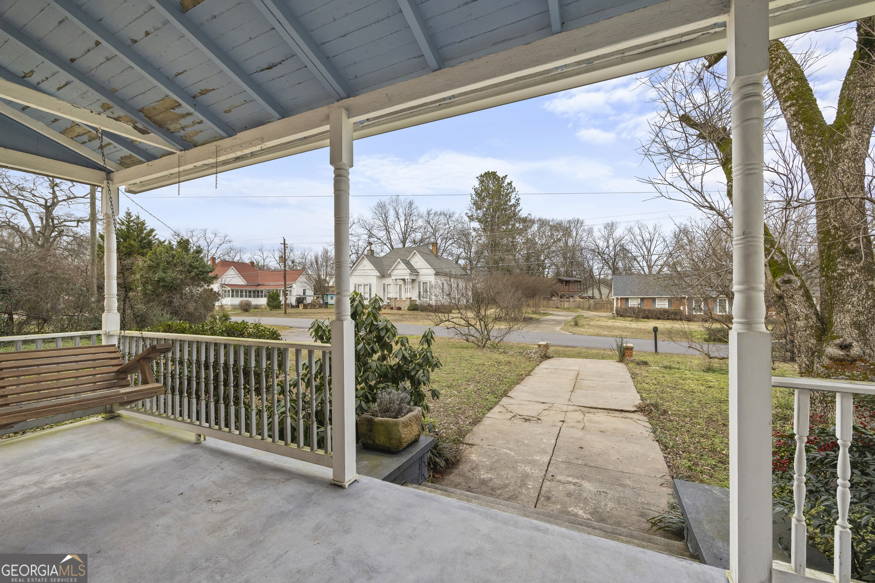 48 Georgia Avenue Comer, GA 30629 - Photo 15 of 46 a view of a porch with a floor to ceiling window with wooden floor