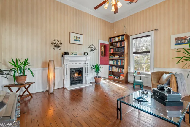 a dining room with furniture a chandelier and wooden floor