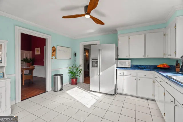 a view of an empty room with workspace and a window