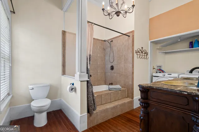 a kitchen with a stove and a wooden floor