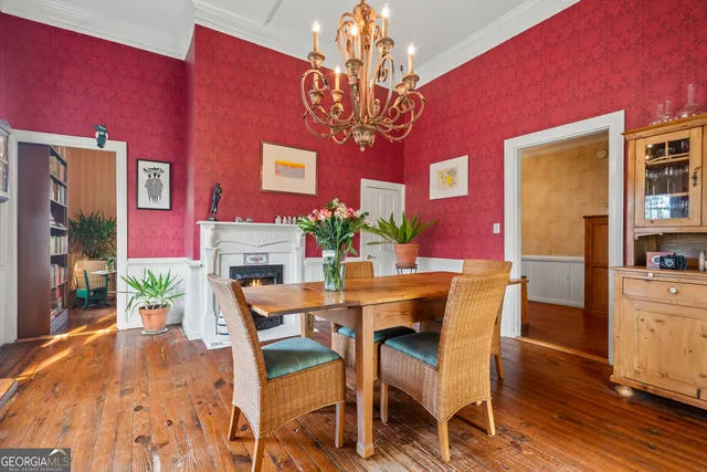 a view of a dining room with furniture and chandelier