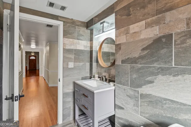 a view of a hallway with wooden floor and closet
