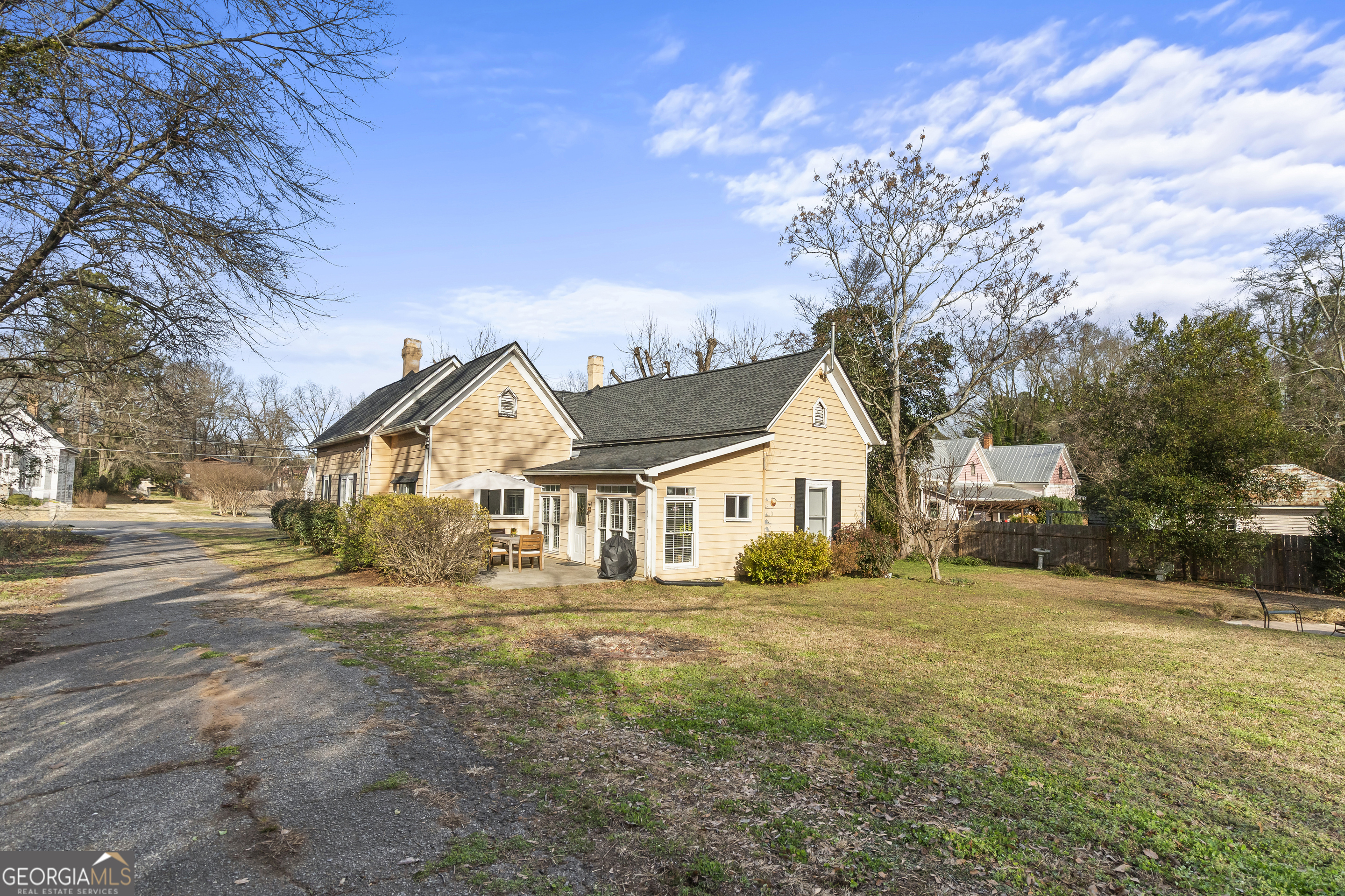 48 Georgia Avenue Comer, GA 30629 - Photo 40 of 46 a front view of a house with a yard covered with trees