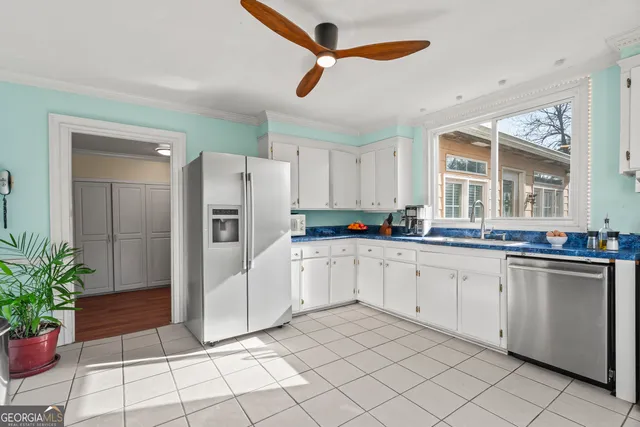 a kitchen with white cabinets and white appliances