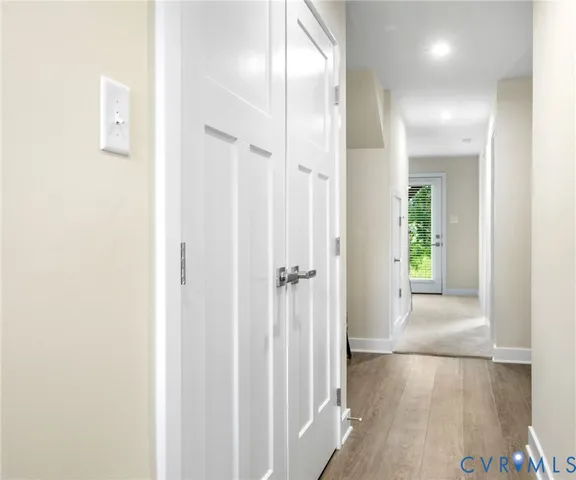 a view of a hallway with wooden floor