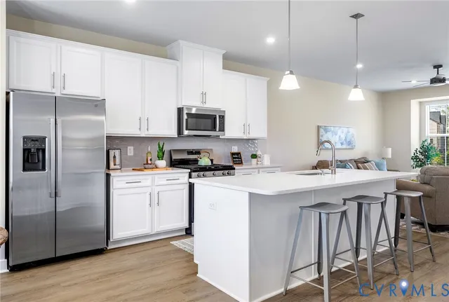 a living room with furniture and kitchen view