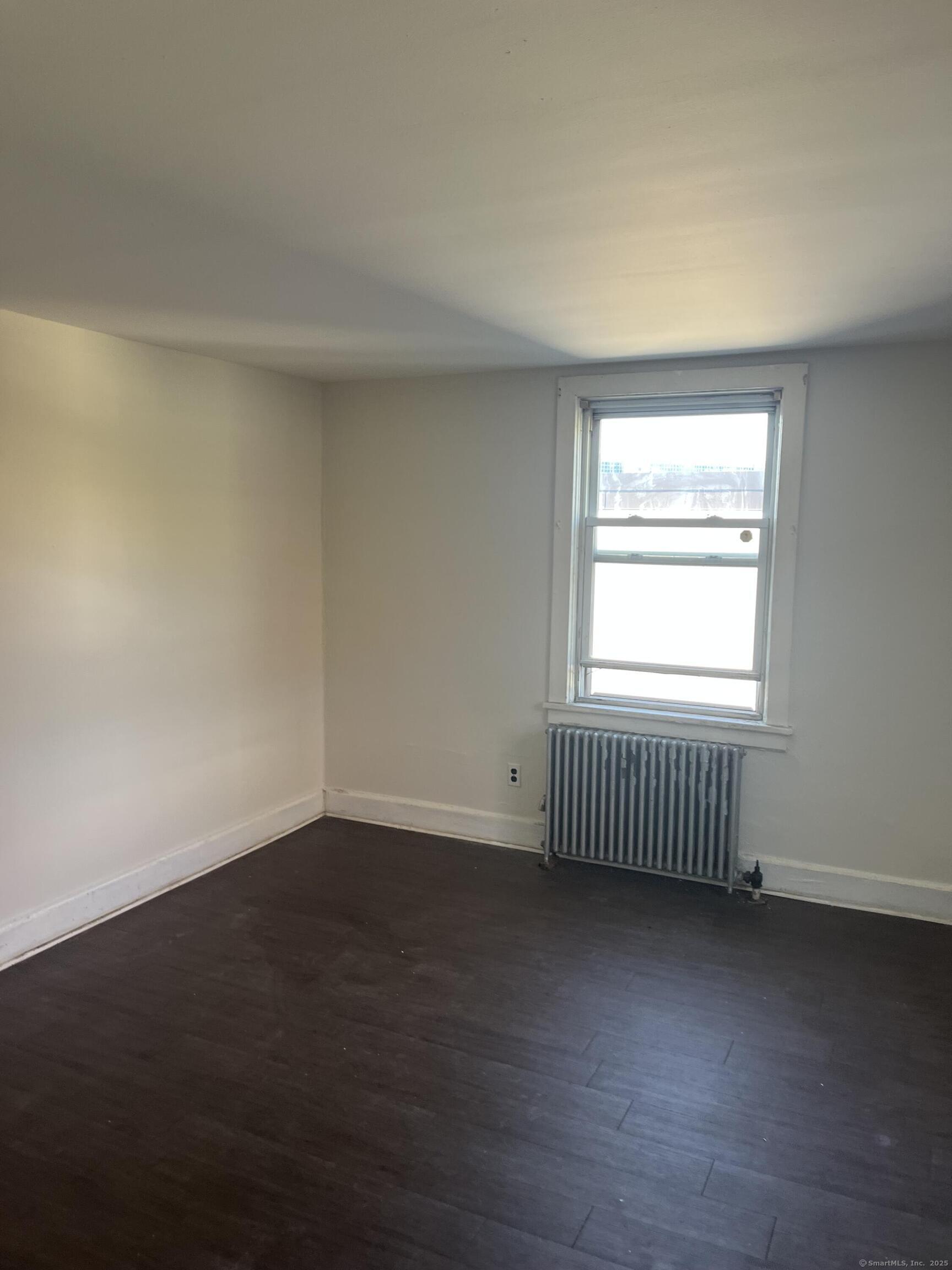 151 View Street Meriden, CT 06450 - Photo 2 of 4 an empty room with wooden floor and a window