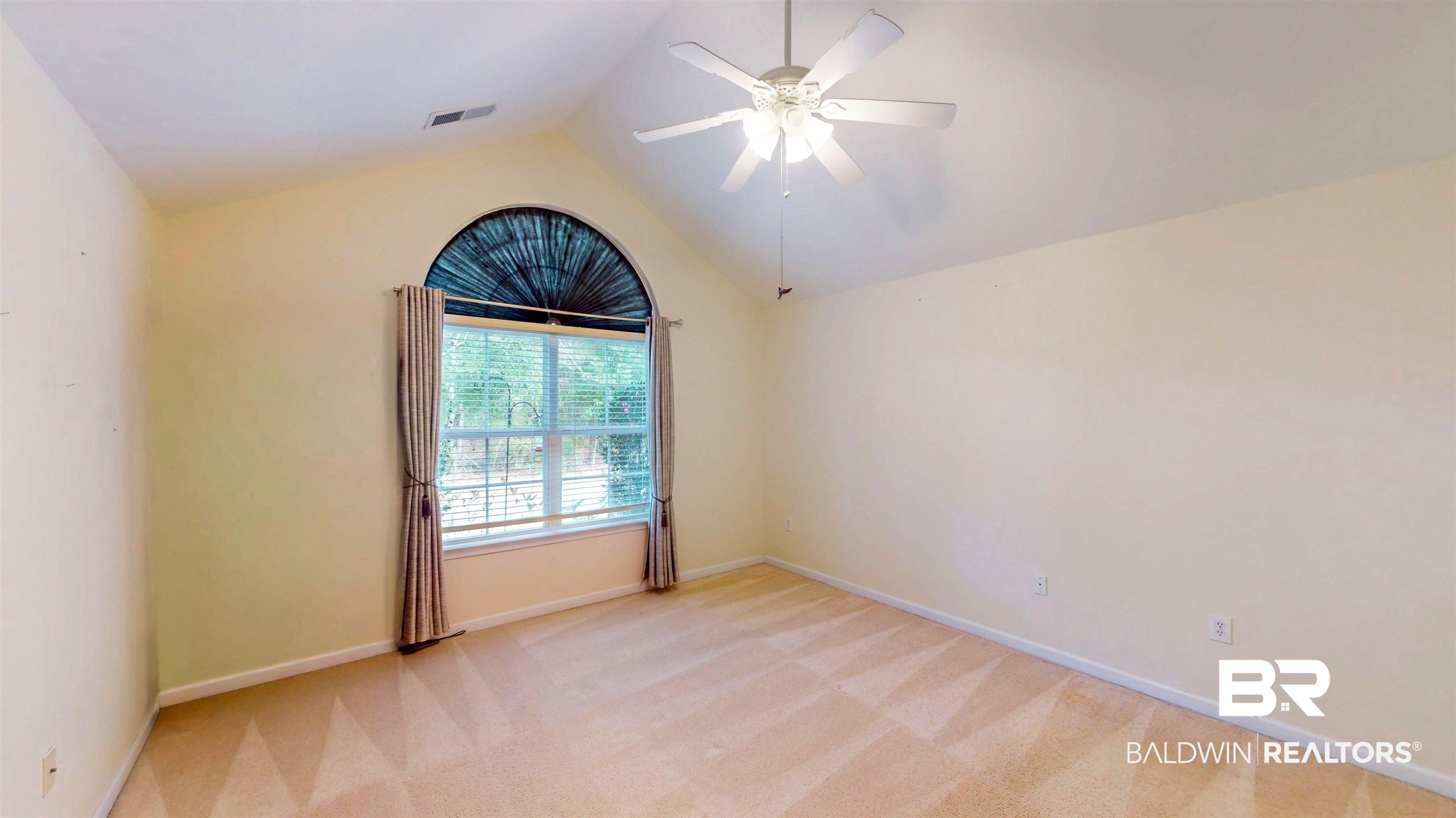 303 Wyld Palms Drive, Unit 303 Foley, AL 36535 - Photo 18 of 36 Unfurnished room with light colored carpet, vaulted ceiling, and ceiling fan