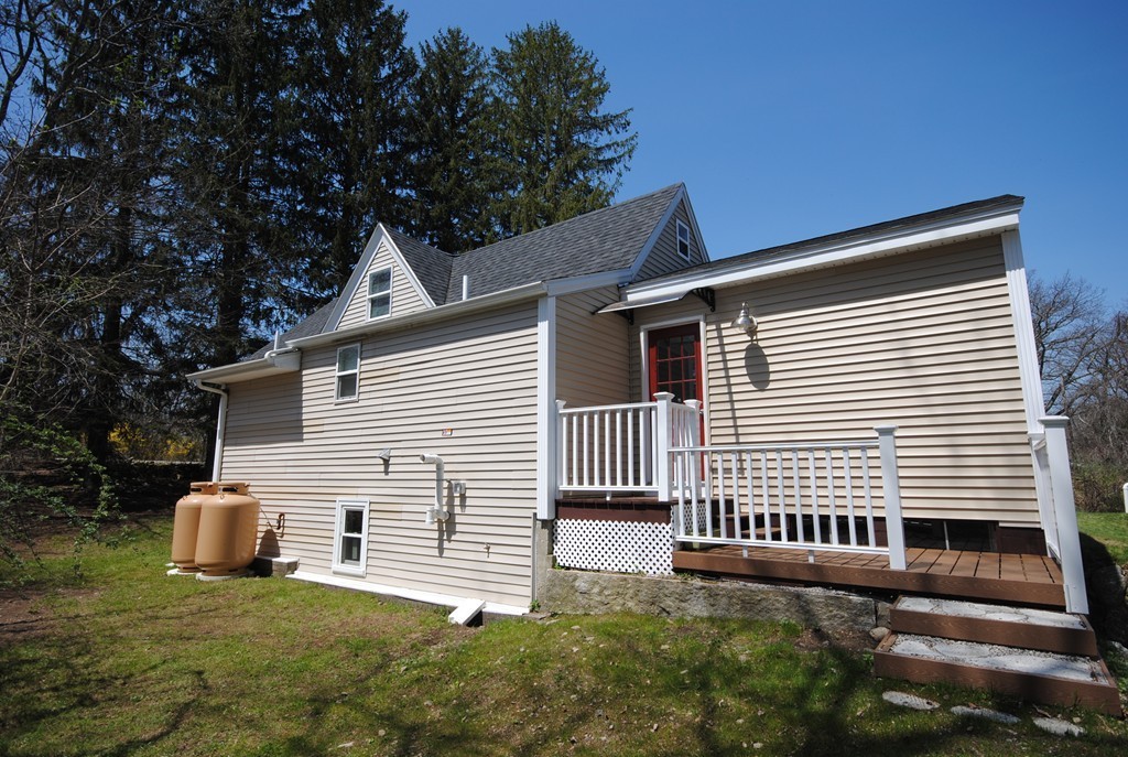 44 Marble Road Sutton, MA 01590 - Photo 2 of 30 a front view of a house with a yard