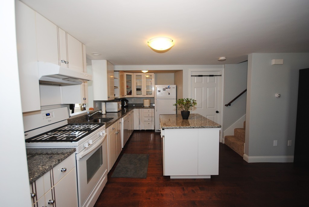44 Marble Road Sutton, MA 01590 - Photo 5 of 30 a kitchen with granite countertop a sink stove and cabinets