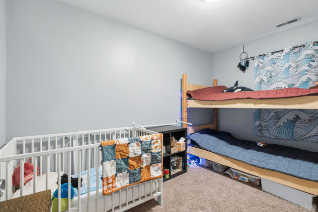 1099 South 950 East, Unit 17 Provo, UT 84606 - Photo 13 of 23 Carpeted room featuring light gray walls and a ceiling-mounted light fixture