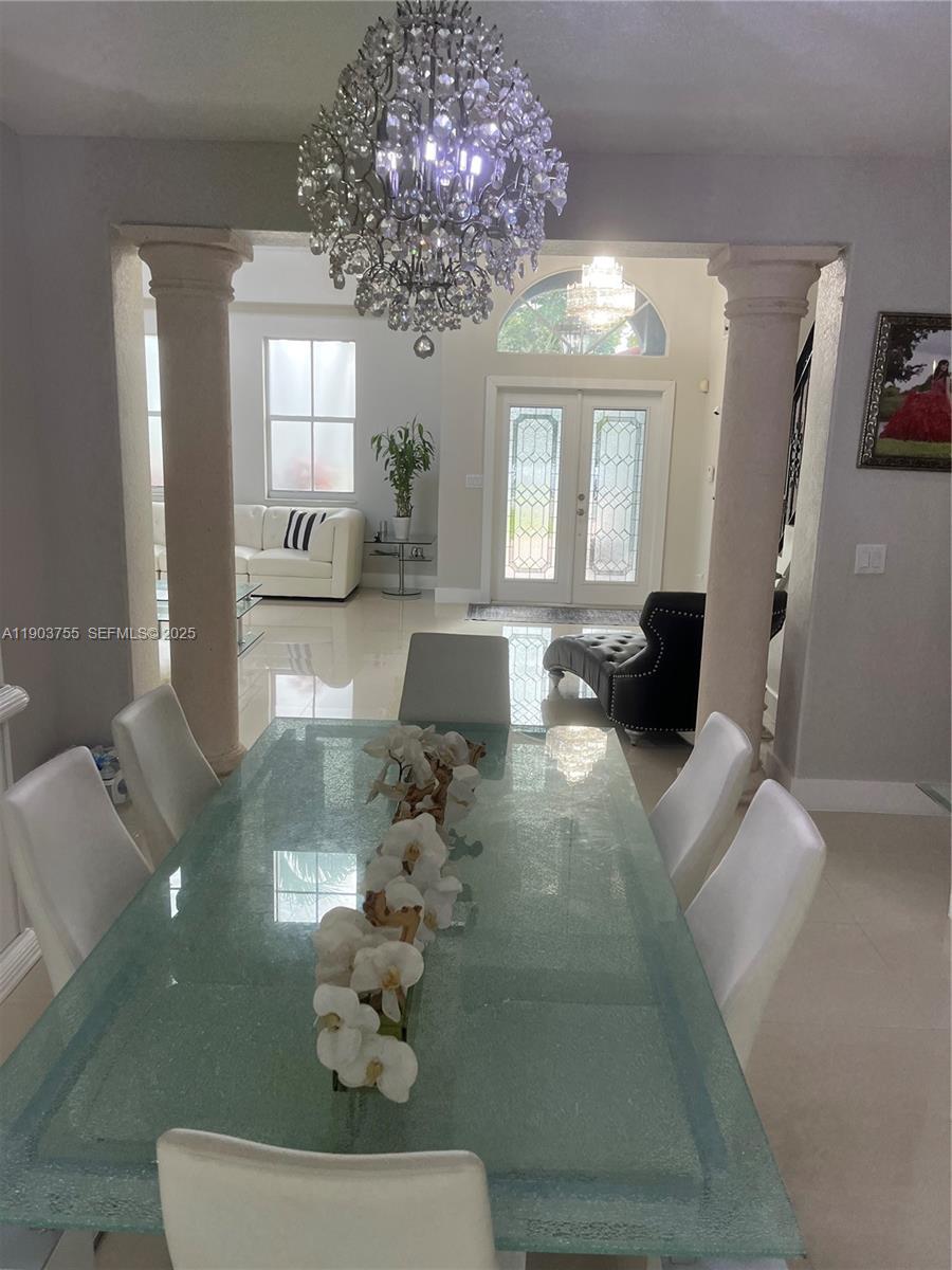 16801 Southwest 38th Street Miramar, FL 33027 - Photo 11 of 63 a living room with furniture and a chandelier