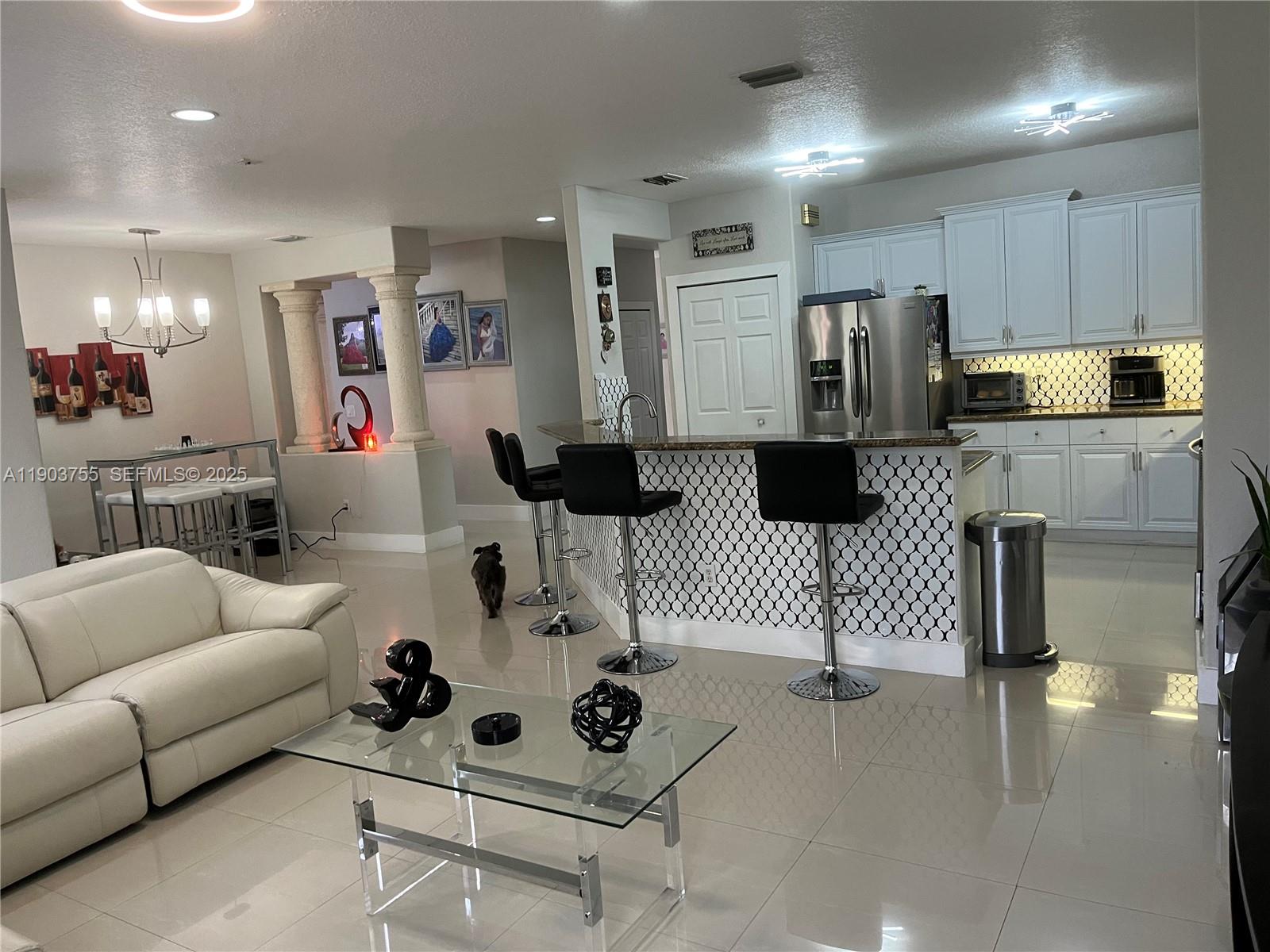16801 Southwest 38th Street Miramar, FL 33027 - Photo 16 of 63 a living room with furniture and a wooden floor