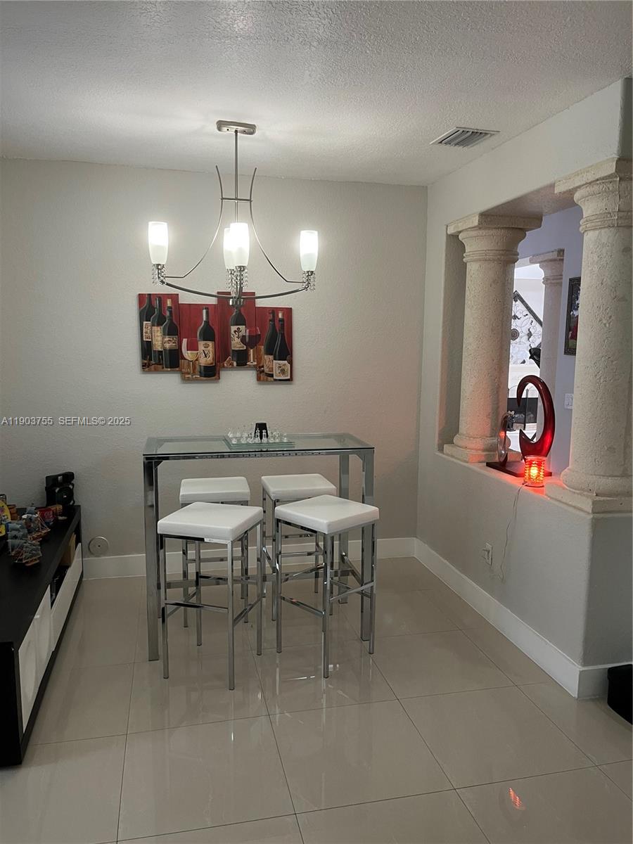 16801 Southwest 38th Street Miramar, FL 33027 - Photo 18 of 63 a view of a dining room with furniture and chandelier