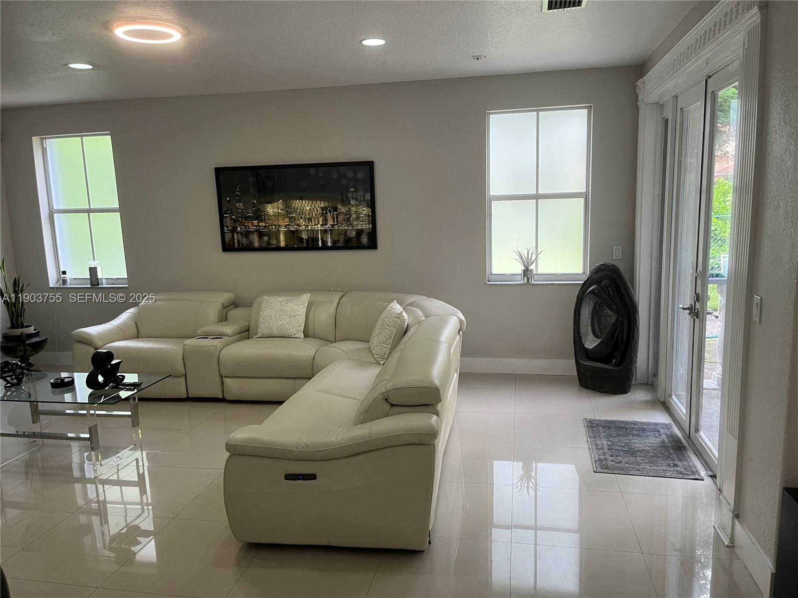16801 Southwest 38th Street Miramar, FL 33027 - Photo 19 of 63 a living room with furniture and a large window