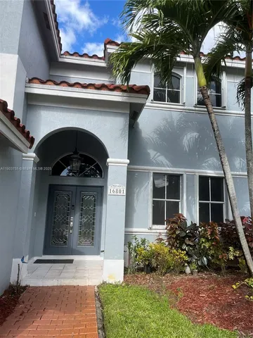 front view of a house with potted plants