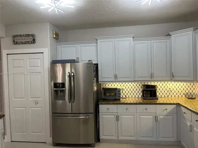 a bathroom with a granite countertop toilet sink and shower