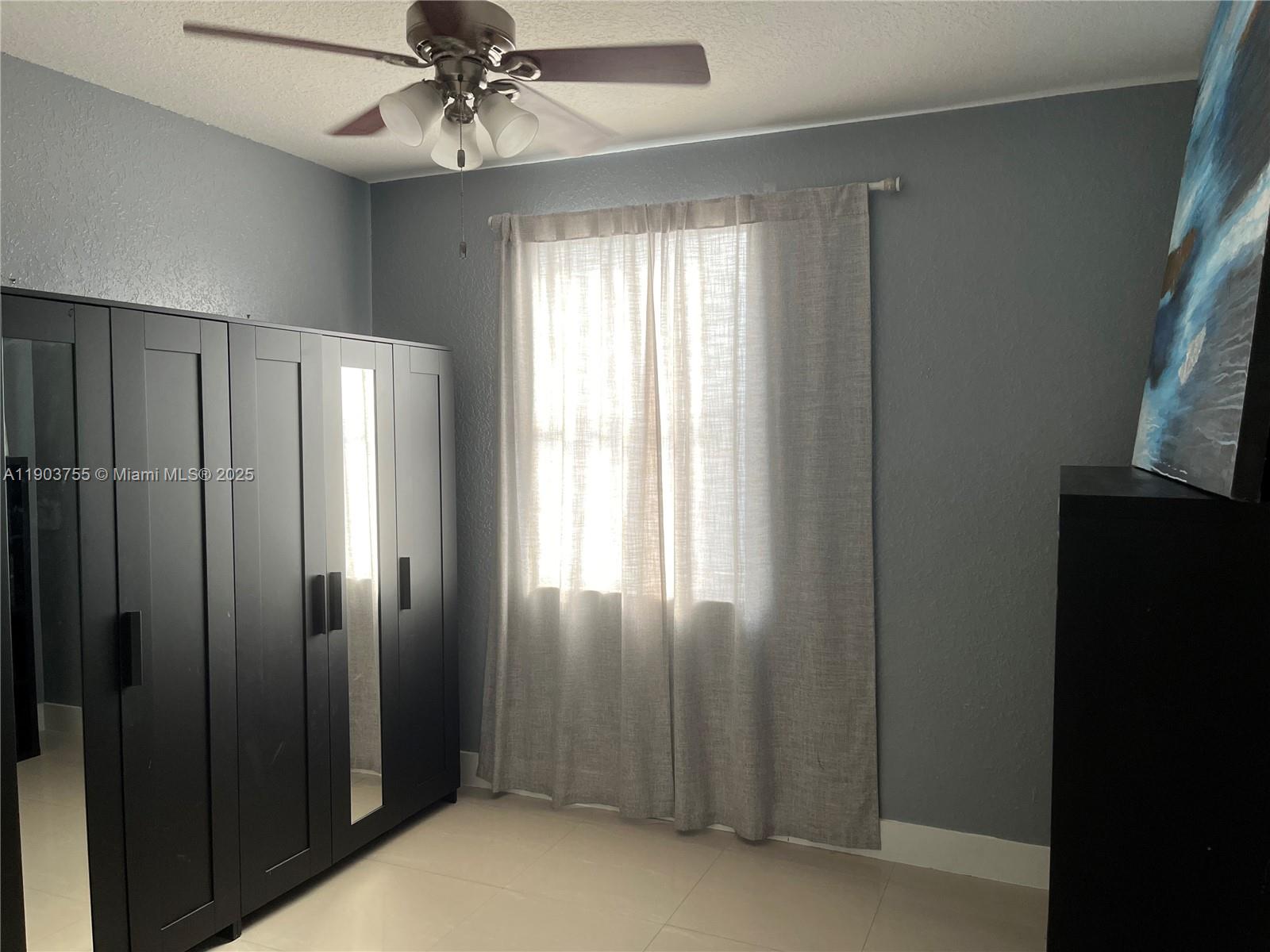16801 Southwest 38th Street Miramar, FL 33027 - Photo 30 of 63 a view of a hallway with windows and chandelier fan