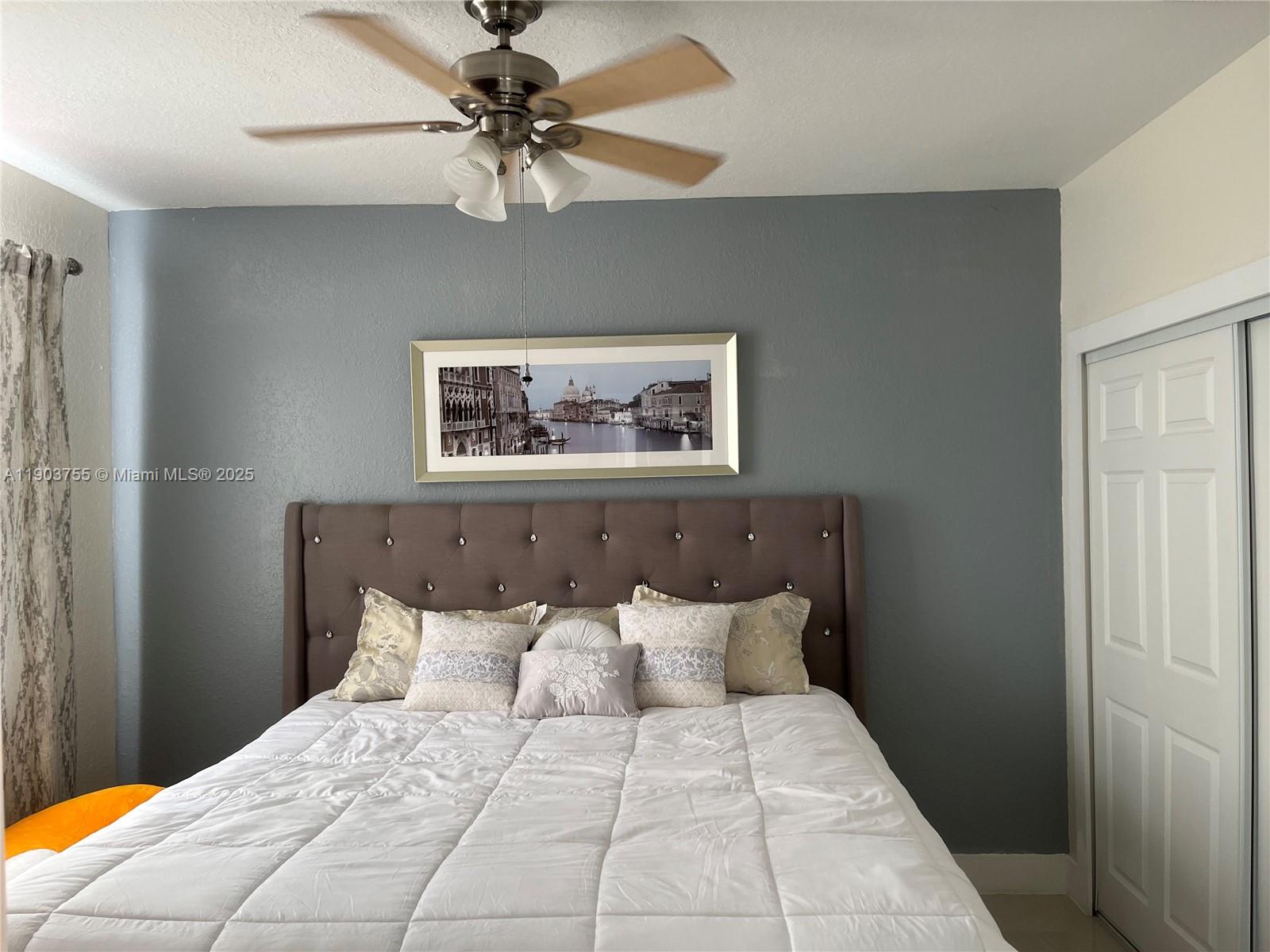 16801 Southwest 38th Street Miramar, FL 33027 - Photo 32 of 63 a bedroom with a large bed and a chandelier
