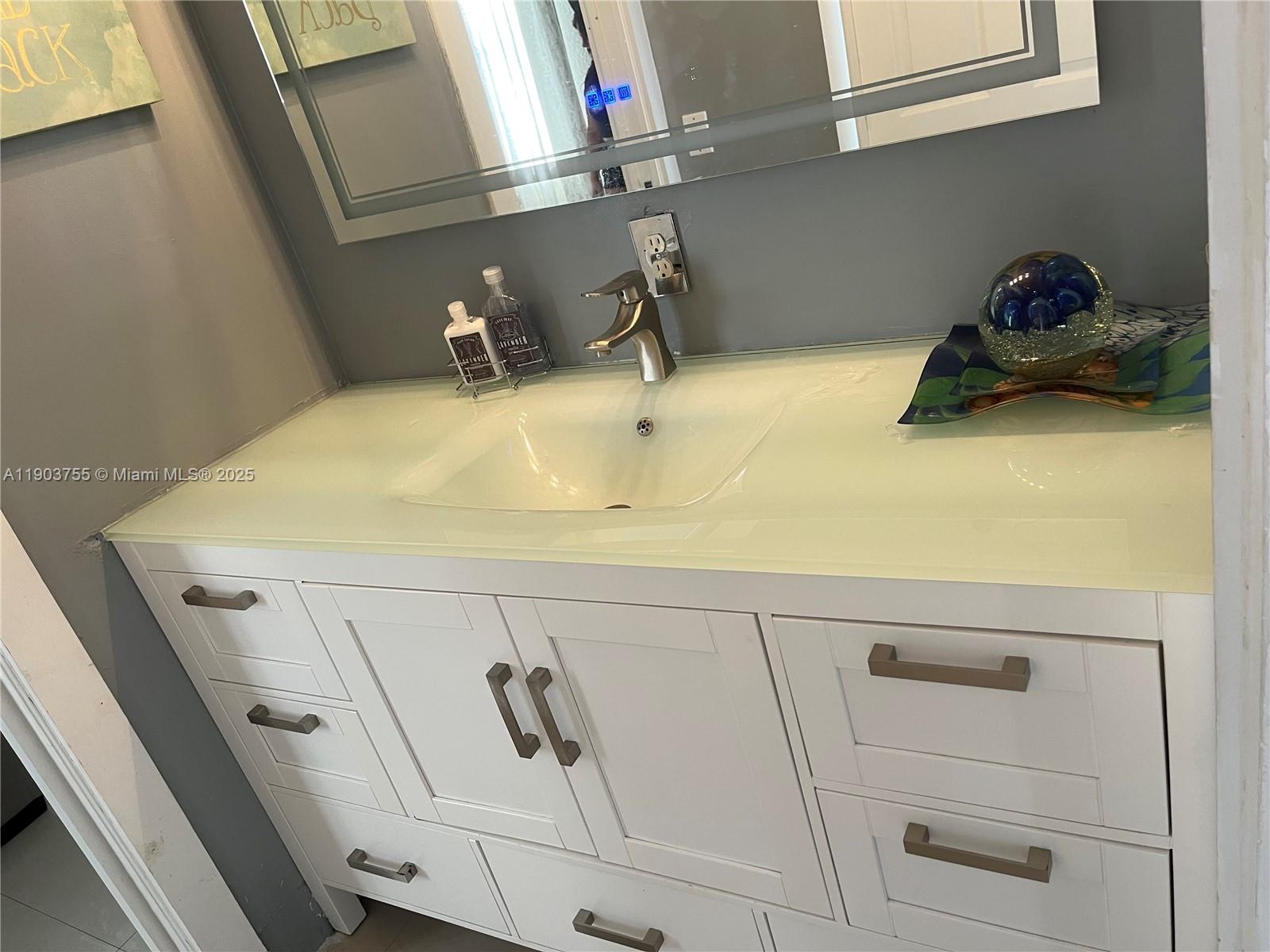 16801 Southwest 38th Street Miramar, FL 33027 - Photo 34 of 63 a bathroom with a sink and vanity