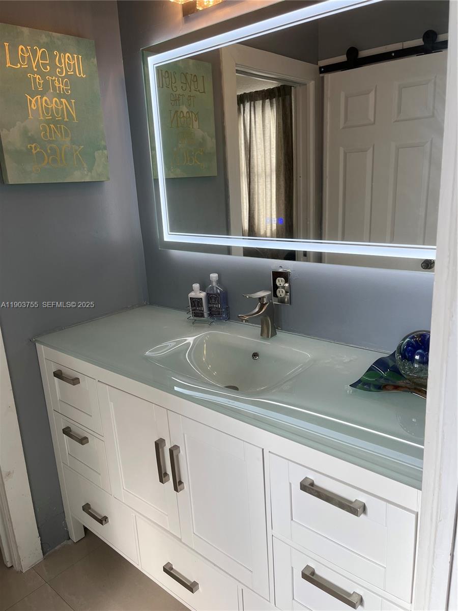 16801 Southwest 38th Street Miramar, FL 33027 - Photo 36 of 63 a bathroom with a sink and a mirror