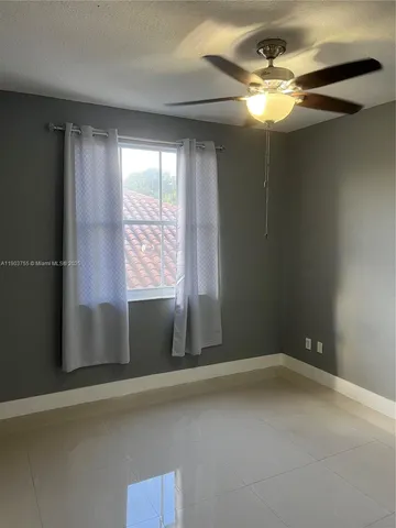 a bedroom with a bed couch and window