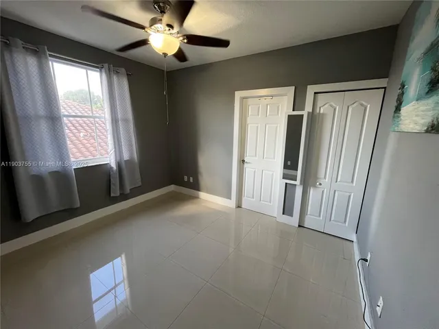 a bedroom with bed and a couch